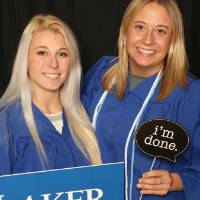 two women smiling with props GradFest